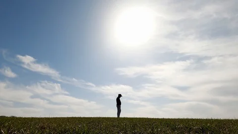 The guy stands on his hands in the middle of the field. Stock Footage 127640400