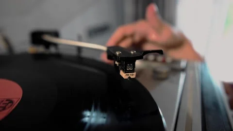 The guy starts up an old vinyl record player. Nice close-up Stock Footage 134433498
