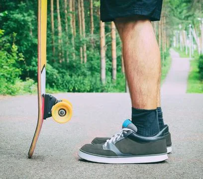 Guy staying with longboard 写真素材