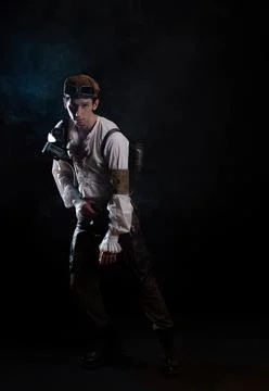 A guy in a steampunk image, a pilot or a mechanic. Retro style, fantastic image. Stock Photos