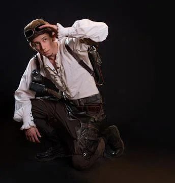 A guy in a steampunk image, a pilot or a mechanic. Retro style, fantastic image. Stock Photos