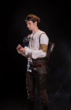 A guy in a steampunk image, a pilot or a mechanic. Retro style, fantastic image. Stock Photos