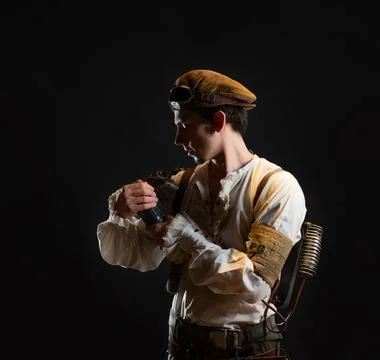 A guy in a steampunk image, a pilot or a mechanic. Retro style, fantastic image. Stock Photos
