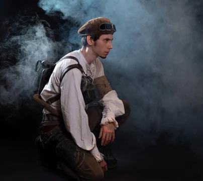A guy in a steampunk image, a pilot or a mechanic. Retro style, fantastic image. Stock Photos