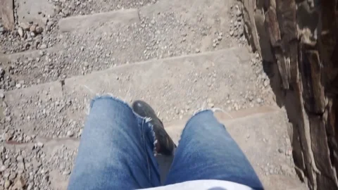 Guy steps down the stairs 스톡 동영상 102781712