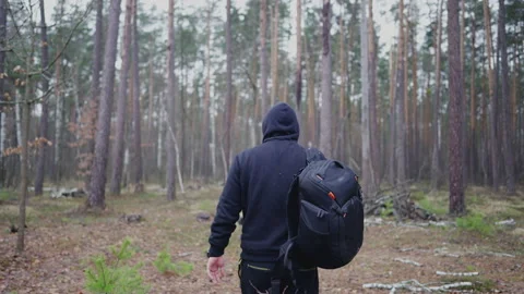 The guy stopped in a clearing in the forest to look around. Stock Footage 231716845