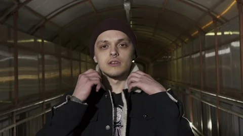 Guy straightens the collar on the jacket and looks into the camera Stock Footage 80480188