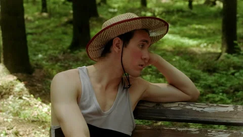 A guy in a straw hat tells something to a girl Stock Footage 197480746