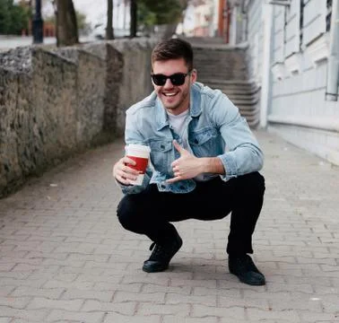 Guy on the street drinking coffee Stock Photos