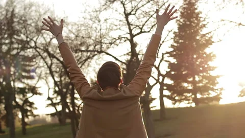 A guy stretching his arms enjoys the sunlight and nature Video stock 88558690