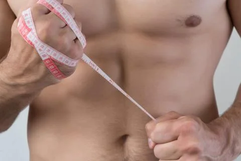 The guy struggles with excess weight. The meter is wound on a fist Stock Photos
