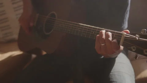 Guy Strums Guitar On Couch Stock Footage 208782692