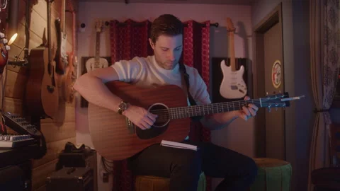 Guy Strums Guitar In Studio Stock Footage 270311636