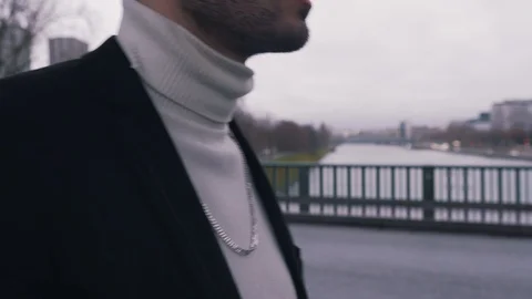 A guy with stubble walks around the city Stock Footage 128523059