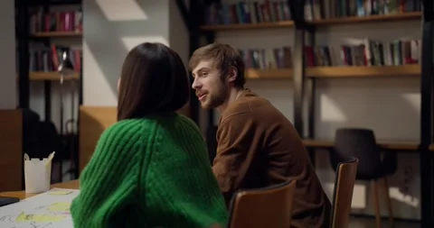 A guy student communicates with his female colleague and discusses his ideas at Stock Footage 313356275