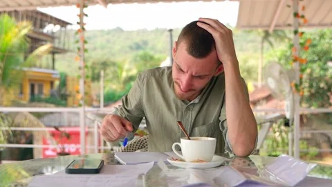 The guy, stumped by his work, nervously takes notes in his notebook. Video stock 231336539