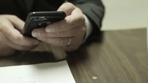 Guy In Suit Hold iPhone Close Up Depth Of Field Video stock 72875635