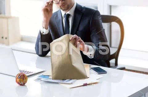 Guy in suit is sitting at table with his correspondence Stock Photos