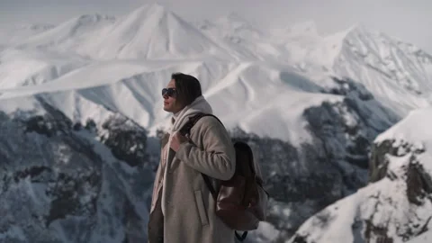 The guy in sunglasses climbs the mountains Stock Footage 169815610