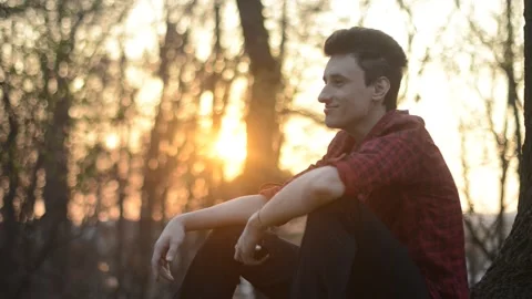 A guy at sunset smokes an e-cigarette. Vape. Vapping	 Stock Footage 130541926