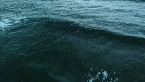Guy surfing in deep blue sea Stock Footage 241936969