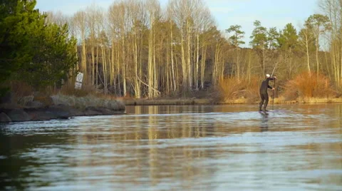 Guy surfs on river Stock Footage 64362945