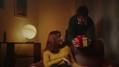 Guy surprise his girlfriend with gift box for valentines day Stock Footage 168816664