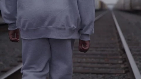 Guy In Sweatsuit Walks On Train Tracks Stock Footage 270325419