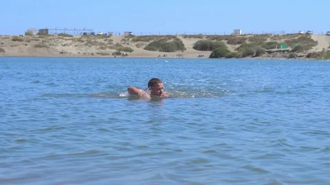 The guy swims in the lake Stock Footage 95163042