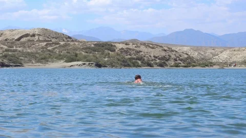 The guy swims in the lake Stock Footage 95164041