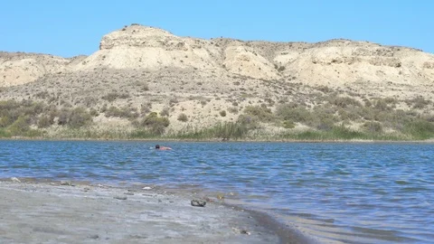 The guy swims in the lake Video stock 96015743