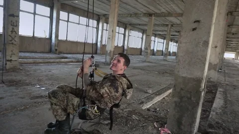 Guy swinging on climbing rope Stock Footage 76315508