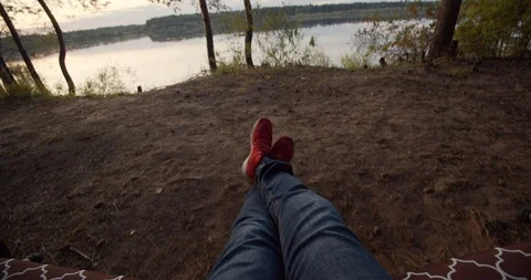 Guy swinging on a swing from the first person Stock Footage 115985972