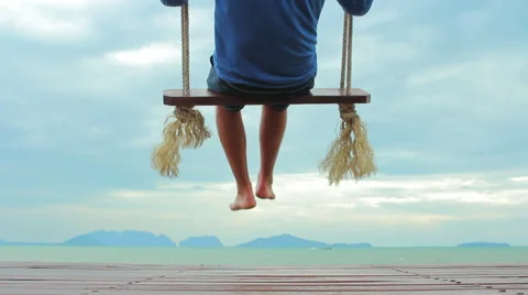 Guy swinging on a swing Stock Footage 64215535