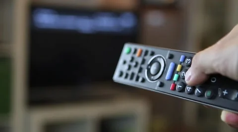 Guy switching through the TV program Stock Footage 67619735