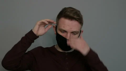 The guy with the symptoms of the disease on a gray background. Video stock 133503901