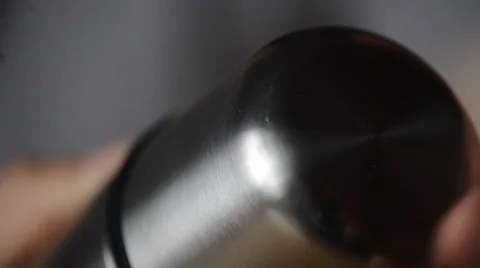 The guy at the table spins cover thermos CU 스톡 동영상 48935827