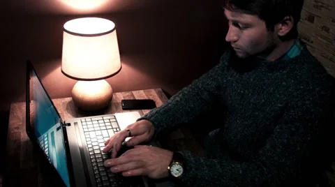 The guy at the table working on laptop and smartphone Stock Footage 56251444