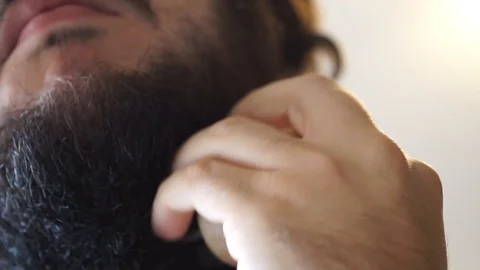 A guy takes care of his beard for Movember Stock Footage 95432860