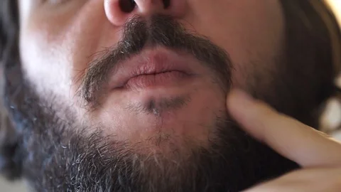 A guy takes care of his beard Stock Footage 95501507
