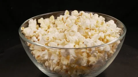 A guy takes popcorn with his hand from a bowl. Stock Footage 307008422