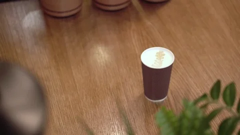 Guy takes prepared coffee away from the table Stock Footage 85404433