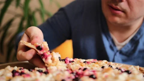The guy takes a slice of sweet pizza Stock-Footage 149314389