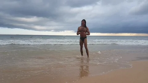 Guy takes a walk along the beach in sri lanka Stock Footage 114928866