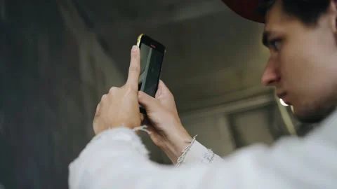 The guy takes off the wall on the phone after it is finished by builders Stock Footage 160336872