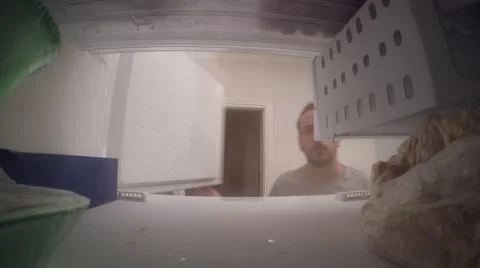 A guy taking ice from freezer Stock Footage 67273529