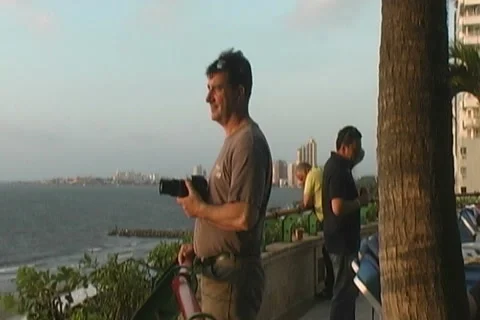 Guy Taking Pictures In Sunset Stock Footage 1000420