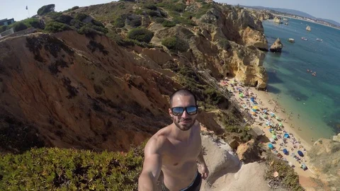 Guy Taking a Selfie in Algarve Beach, Portugal Stock Footage 79468567
