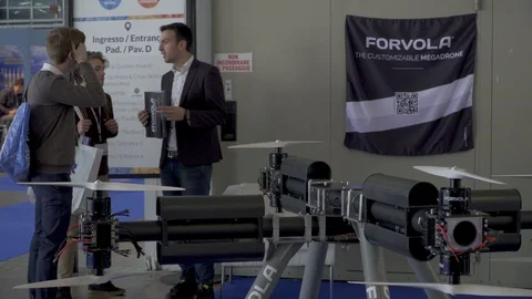 Guy talking about mega drone at a convention Stock Footage 88545822