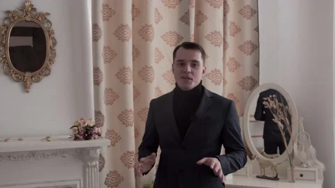 The guy is talking to the camera. In a classic suit. Stock Footage 130222499